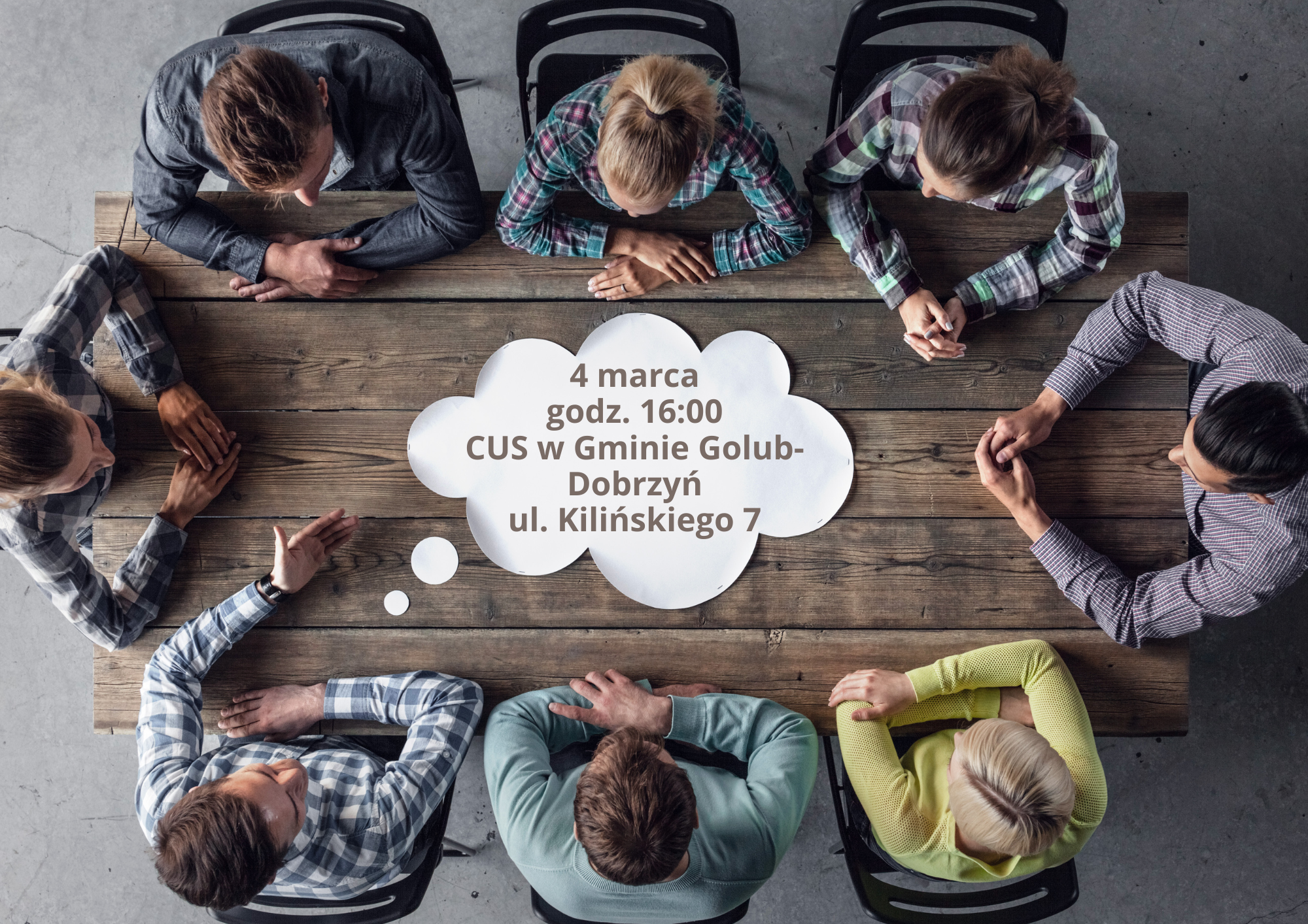 Osoby siedzące przy stole prostokątnym